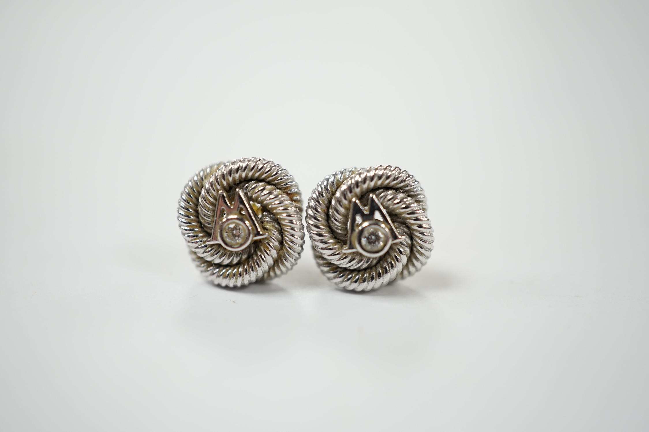 A pair of 750 and diamond chip set 'knot' ear studs with Boodles & Dunthorne butterflies, gross weight 5.2 grams. Condition - fair
